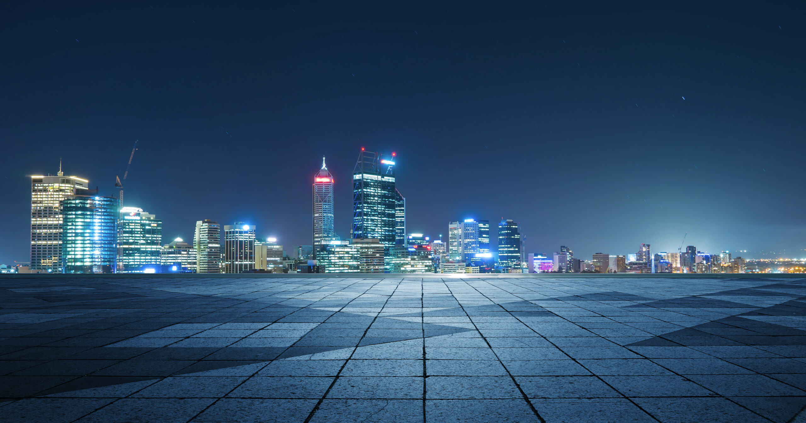 Panoramic skyline and buildings with empty concrete square floor,night scene